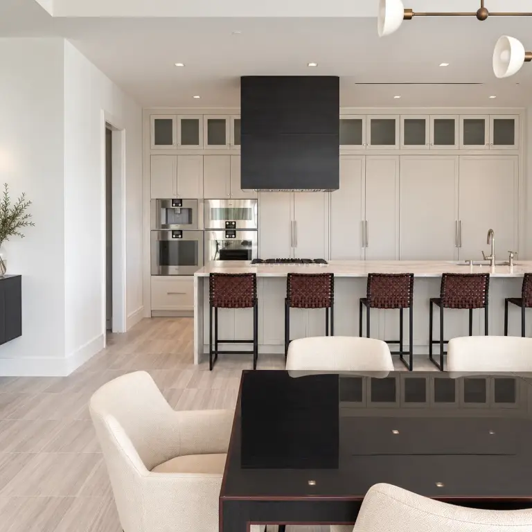 White kitchen and dining area at BH Condo