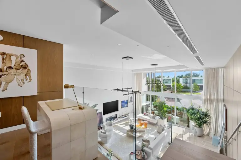 Mezzanine study overlooking the double-height living room at Starr DeVos Condo