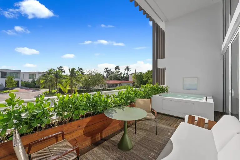 Terrace with a private plunge pool, wood decking and an outdoor sofa at Starr DeVos Condo